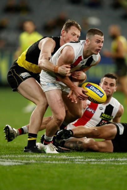 Jack Higgins of the Saints handballs during the round 15 AFL match between the Richmond Tigers and the St Kilda Saints at Melbourne Cricket Ground on...