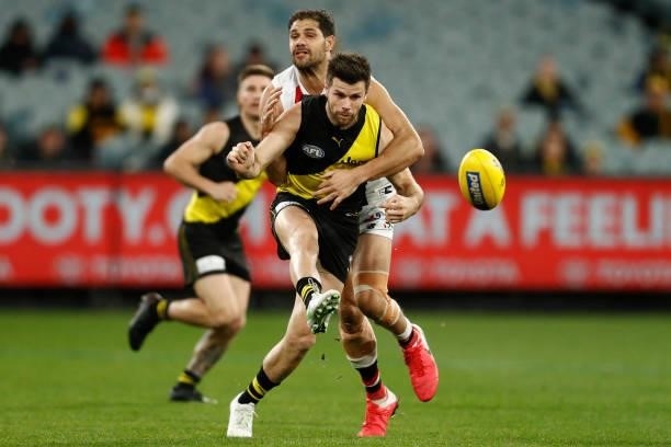 Paddy Ryder of the Saints tackles Trent Cotchin of the Tigers during the round 15 AFL match between the Richmond Tigers and the St Kilda Saints at...
