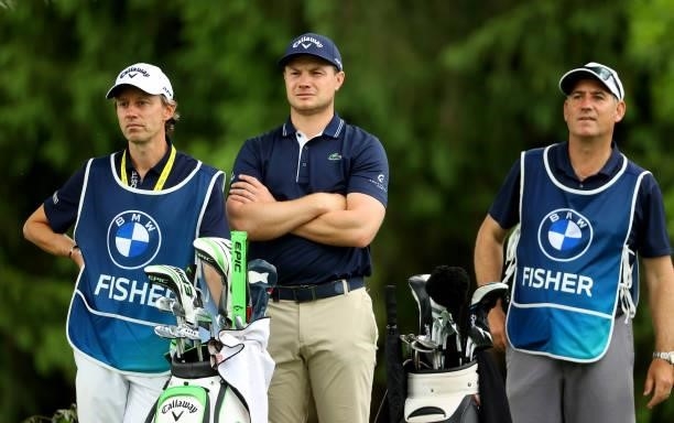 Oliver Fisher of England with his caddie and the caddie of Ross Fisher of England on the 13th tee during the second round of The BMW International...