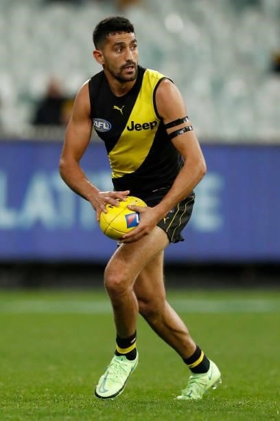 Marlion Pickett of the Tigers runs with the ball during the round 15 AFL match between the Richmond Tigers and the St Kilda Saints at Melbourne...