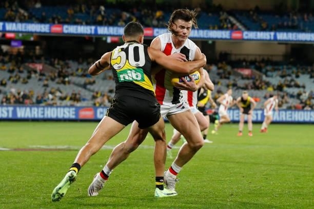 Marlion Pickett of the Tigers tackles Jack Sinclair of the Saints during the round 15 AFL match between the Richmond Tigers and the St Kilda Saints...