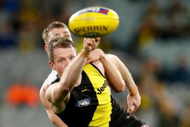 Mason Wood of the Saints and Dylan Grimes of the Tigers compete during the round 15 AFL match between the Richmond Tigers and the St Kilda Saints at...
