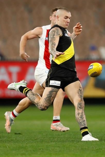 Dustin Martin of the Tigers kicks the ball during the round 15 AFL match between the Richmond Tigers and the St Kilda Saints at Melbourne Cricket...