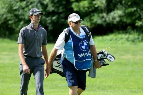 Elvis Symlie of Australia and his caddie Michael Waite on the 18th hole during the second round of The BMW International Open at Golfclub Munchen...