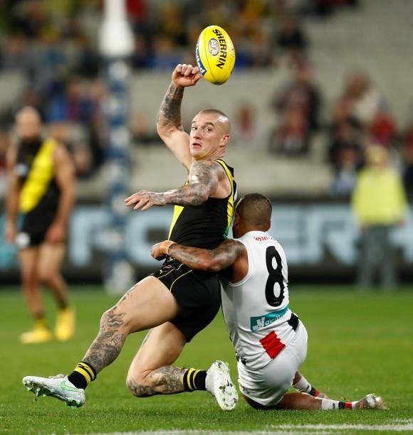 Bradley Hill of the Saints tackles Dustin Martin of the Tigers during the round 15 AFL match between the Richmond Tigers and the St Kilda Saints at...