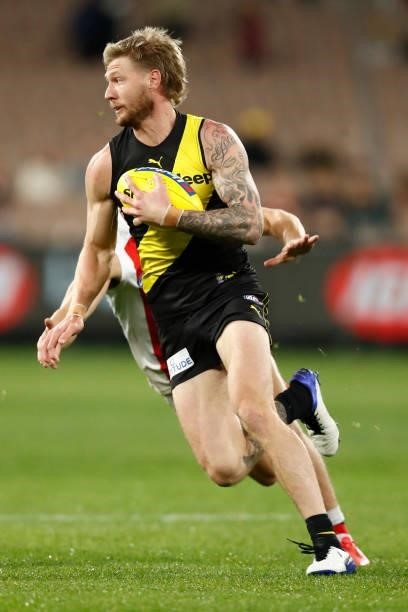 Nathan Broad of the Tigers runs with the ball during the round 15 AFL match between the Richmond Tigers and the St Kilda Saints at Melbourne Cricket...