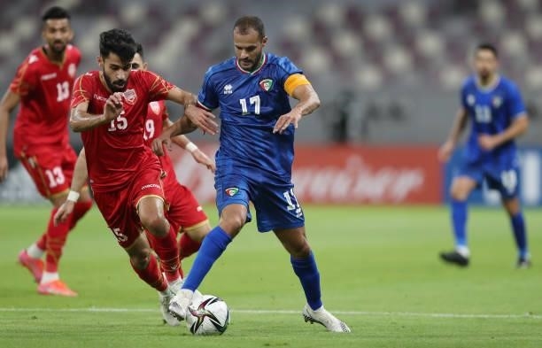Jasim Alshaikh of Bahrain and Bader Almotawaa of Kuwait battle for the ball during the FIFA Arab Cup 2021 Qualifying match between Bahrain and Kuwait...
