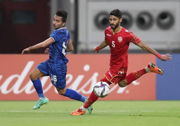 Mobarak Alfaneeni of Kuwait and Ahmed Bughammar of Bahrain battle for the ball during the FIFA Arab Cup 2021 Qualifying match between Bahrain and...