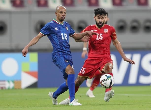 Hamad Alharbi of Kuwait and Jasim Alshaikh of Bahrain battle for the ball during the FIFA Arab Cup 2021 Qualifying match between Bahrain and Kuwait...