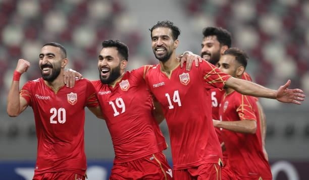 Ali Haram of Bahrain celebrates after scoring their team's first goal with teammates Mahdi Alhumaidan and Komail Alaswad during the FIFA Arab Cup...