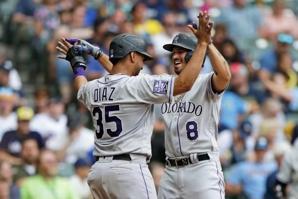 Joshua Fuentes of the Colorado Rockies is congratulated by Elias Diaz after hitting a two run homer in the seventh inning against the Milwaukee...