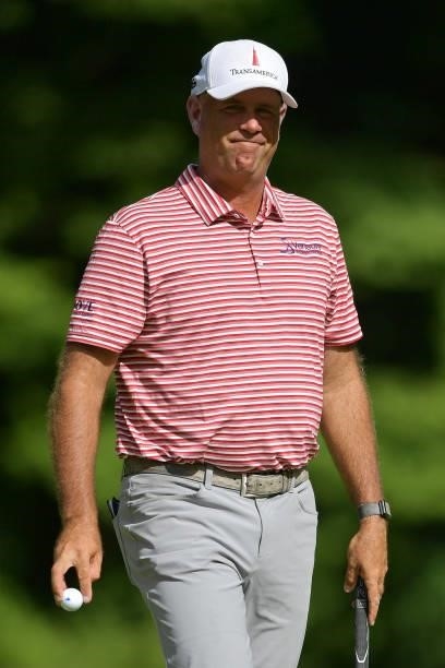 Stewart Cink of the United States reacts to his putt on the 14th green during the second round of the Travelers Championship at TPC River Highlands...