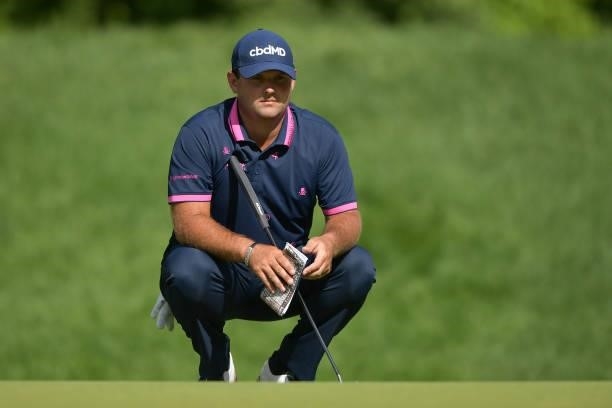 Patrick Reed of the United States looks over a putt on the 14th green during the second round of the Travelers Championship at TPC River Highlands on...