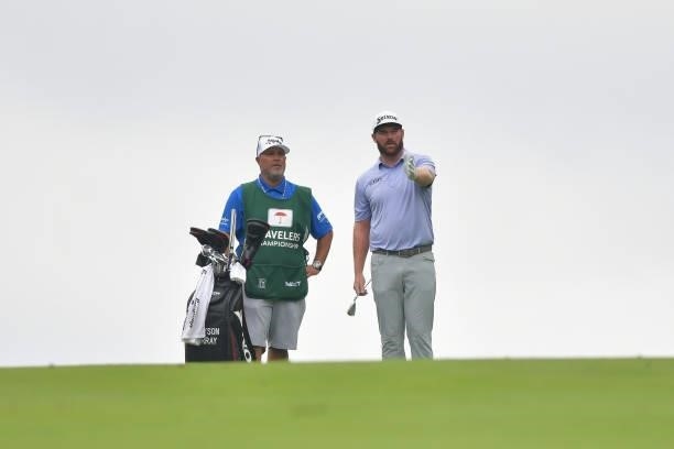 Grayson Murray of the United States talks with his caddie on the 14th hole during the second round of the Travelers Championship at TPC River...