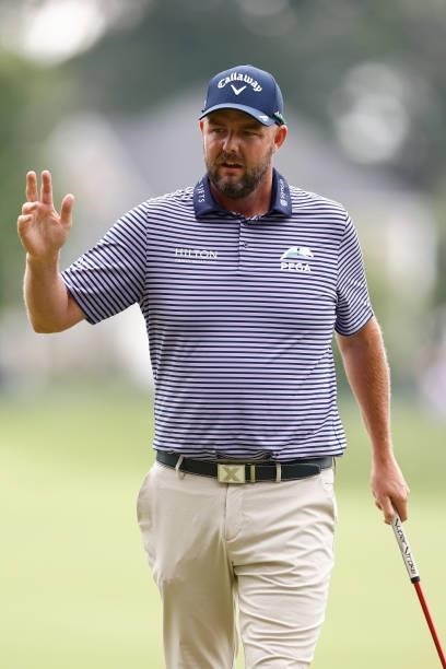 Marc Leishman of Australia reacts to his putt on the seventh green during the second round of the Travelers Championship at TPC River Highlands on...