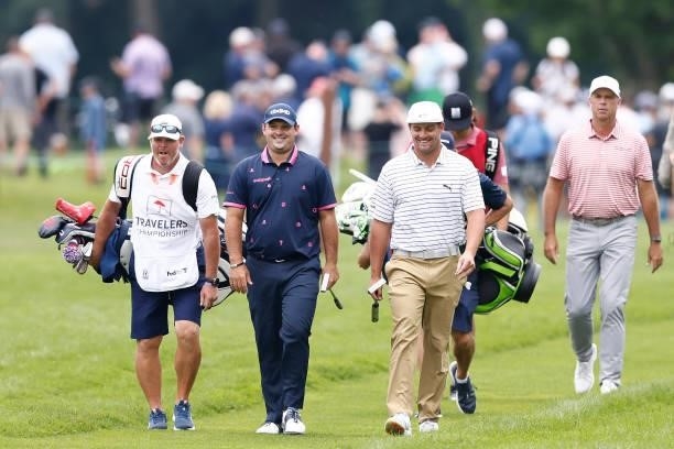 Patrick Reed of the United States and Bryson DeChambeau of the United States laugh as they walk up to the fifth green during the second round of the...
