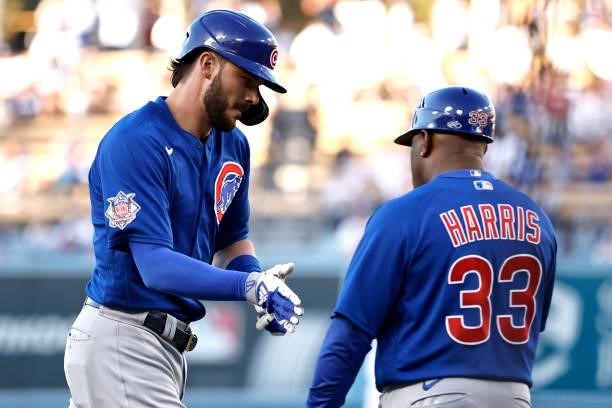 Kris Bryant of the Chicago Cubs celebrates with Willie Harris of the Chicago Cubs as he rounds third base after hitting a solo home run against the...