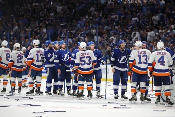 The New York Islanders and Tampa Bay Lightning shake hands after the Lightning's 1-0 victory in Game Seven of the NHL Stanley Cup Semifinals during...