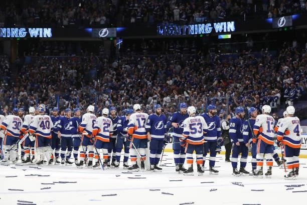 The New York Islanders and Tampa Bay Lightning shake hands after the Lightning's 1-0 victory in Game Seven of the NHL Stanley Cup Semifinals during...