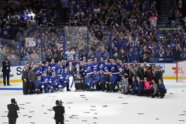 Players and staff of the Tampa Bay Lightning pose with the Prince of Wales Trophy after their 1-0 win against the New York Islanders in Game Seven of...