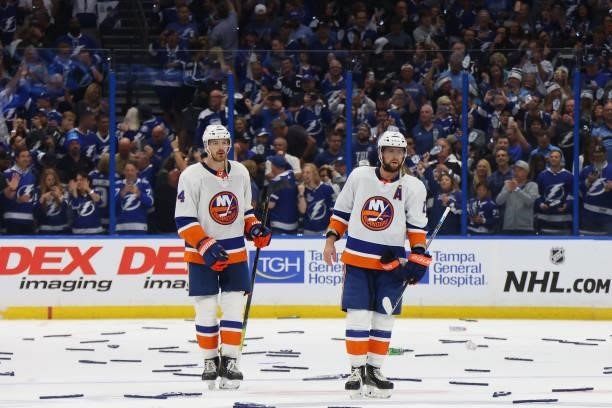 Scott Mayfield and Josh Bailey of the New York Islanders react after their team's 1-0 loss against the Tampa Bay Lightning in Game Seven of the NHL...