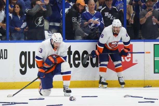 Mathew Barzal and Ryan Pulock of the New York Islanders react after their team's 1-0 loss against the Tampa Bay Lightning in Game Seven of the NHL...
