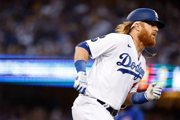 Justin Turner of the Los Angeles Dodgers makes a run after hitting a double against the Chicago Cubs during the third inning at Dodger Stadium on...
