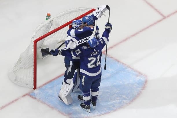 Andrei Vasilevskiy, Brayden Point and Victor Hedman of the Tampa Bay Lightning celebrate after defeating the New York Islanders 1-0 in Game Seven of...