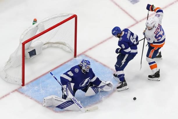 Andrei Vasilevskiy of the Tampa Bay Lightning makes the save against Casey Cizikas of the New York Islanders as Tyler Johnson defends during the...