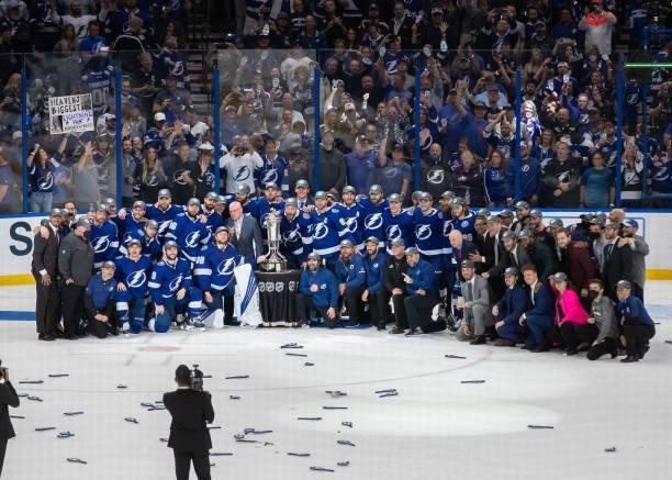 Players and staff of the Tampa Bay Lightning pose with the Prince of Wales Trophy after their 1-0 win against the New York Islanders in Game Seven of...