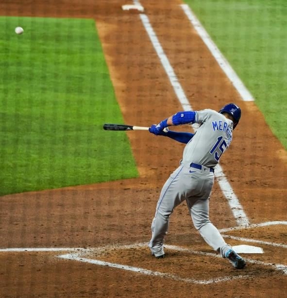 Whit Merrifield of the Kansas City Royals hits for a triple during the game against the Texas Rangers at Globe Life Field on June 25, 2021 in...