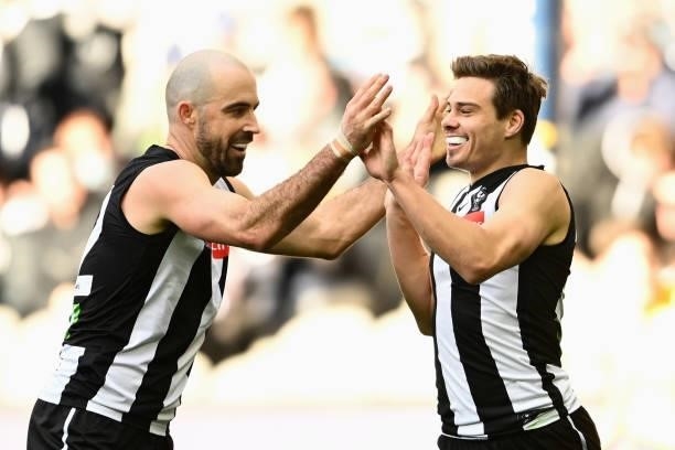 Josh Thomas of the Magpies is congratulated by Steele Sidebottom of the Magpies after scoring a goal during the round 15 AFL match between the...