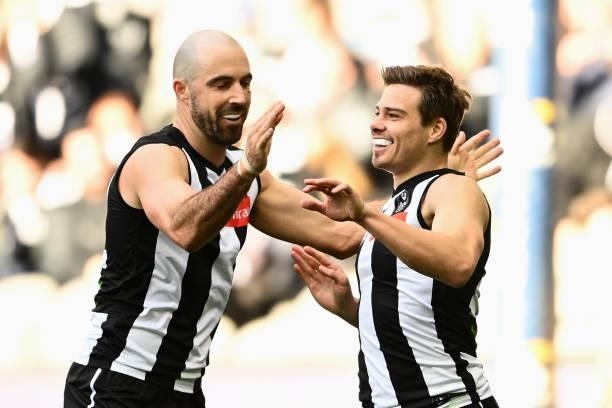 Josh Thomas of the Magpies is congratulated by Steele Sidebottom of the Magpies after scoring a goal during the round 15 AFL match between the...