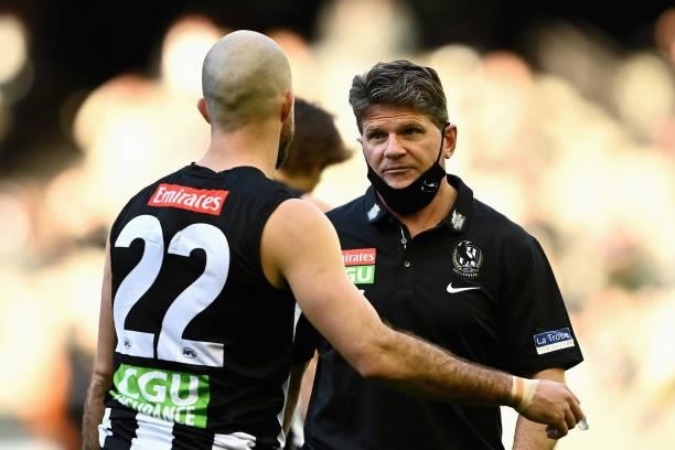 Collingwood caretaker coach Robert Harvey talks to Steele Sidebottom of the Magpies during the round 15 AFL match between the Collingwood Magpies and...