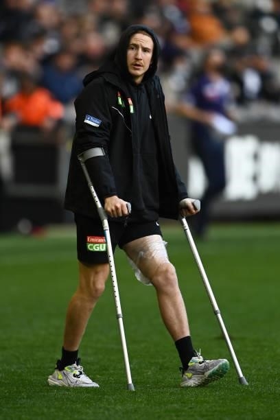 Beau McCreery of the Magpies enters the field after retiring from the match injured during the round 15 AFL match between the Collingwood Magpies and...