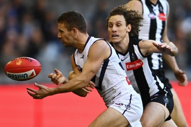 Sam Switkowski of the Dockers is tackled by Chris Mayne of the Magpies during the round 15 AFL match between the Collingwood Magpies and the...