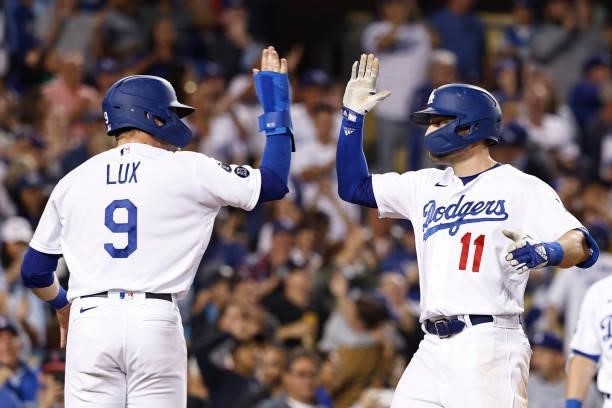 Pollock of the Los Angeles Dodgers celebrates with Gavin Lux of the Los Angeles Dodgers after hitting a two run home run against the Chicago Cubs...