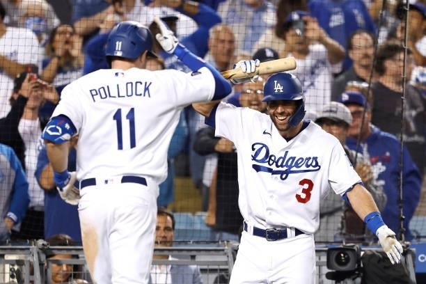 Pollock of the Los Angeles Dodgers celebrates with Chris Taylor of the Los Angeles Dodgers after hitting a two run home run bringing home Gavin Lux...