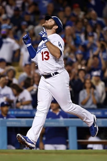 Max Muncy of the Los Angeles Dodgers reacts after hitting a two run home run against the Chicago Cubs bringing home Mookie Betts of the Los Angeles...