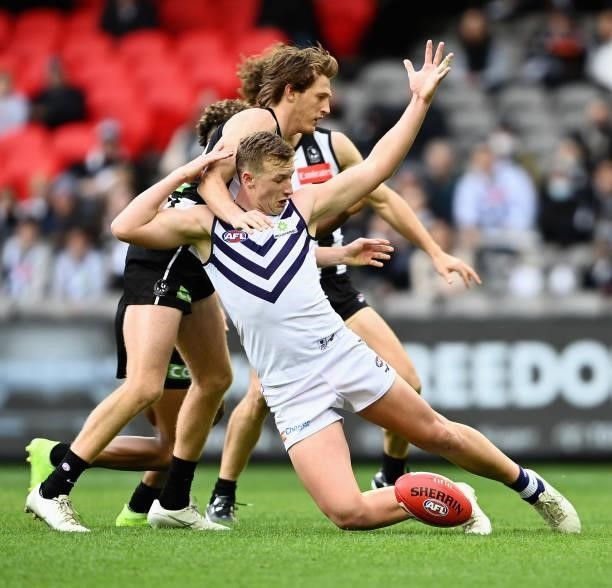 Josh Treacy of the Dockers is tackled during the round 15 AFL match between the Collingwood Magpies and the Fremantle Dockers at Marvel Stadium on...