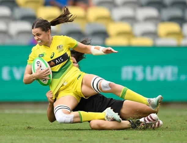 Chloe Dalton of Australia is tackled during the Oceania Sevens Challenge match between New Zealand and Australia at Queensland Country Bank Stadium...