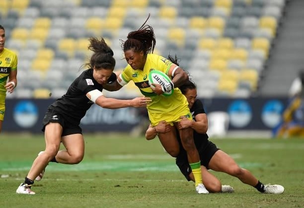 Ellia Green of Australia is tackled by Ruby Tui and Portia Woodman of New Zealand during the Oceania Sevens Challenge match between New Zealand and...