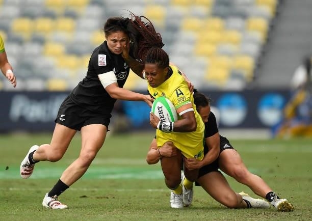 Ellia Green of Australia is tackled by Ruby Tui and Portia Woodman of New Zealand during the Oceania Sevens Challenge match between New Zealand and...