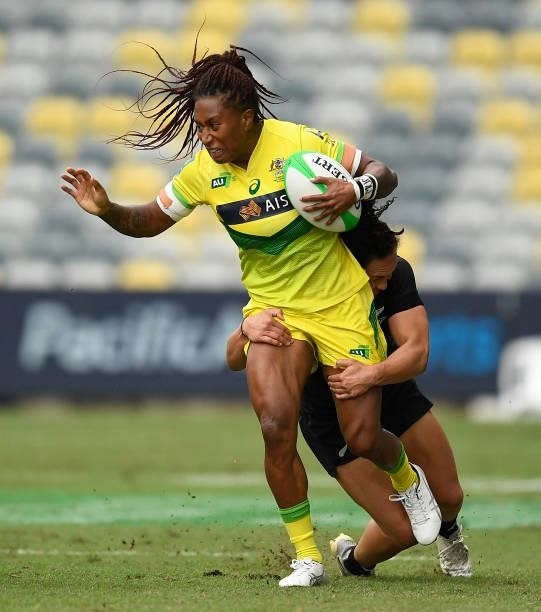 Ellia Green of Australia is tackled during the Oceania Sevens Challenge match between New Zealand and Australia at Queensland Country Bank Stadium on...