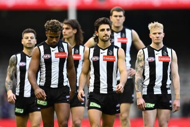 Magpies players look dejected after losing the round 15 AFL match between the Collingwood Magpies and the Fremantle Dockers at Marvel Stadium on June...
