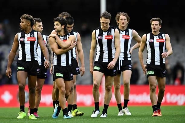 Magpies players look dejected after losing the round 15 AFL match between the Collingwood Magpies and the Fremantle Dockers at Marvel Stadium on June...