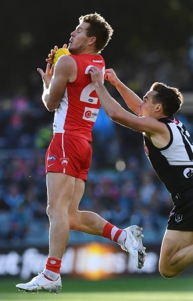 Luke Parker of the Swans marks in front of Karl Amon of Port Adelaide during the round 15 AFL match between the Port Adelaide Power and the Sydney...