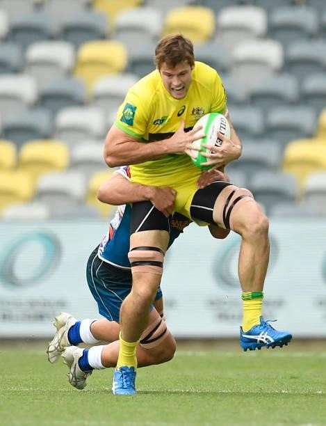 Tim Anstee of Australia is tackled during the Oceania Sevens Challenge match between Australia and Oceania at Queensland Country Bank Stadium on June...