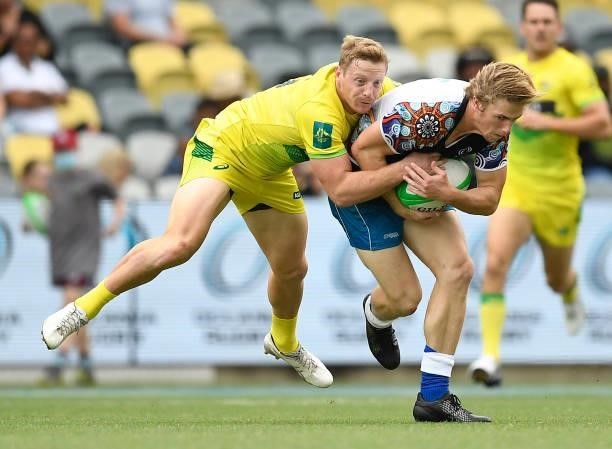 Angus Bell of Oceania is tackled by Lachlan Miller of Australia during the Oceania Sevens Challenge match between Australia and Oceania at Queensland...