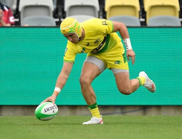 Josh Coward of Australia scores a try during the Oceania Sevens Challenge match between Australia and Oceania at Queensland Country Bank Stadium on...